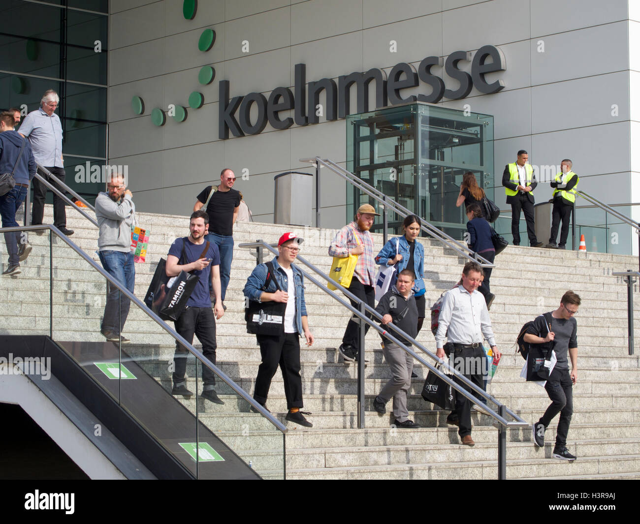 Koeln Messe entrance name sign steps with people in Cologne, Germany Stock Photo