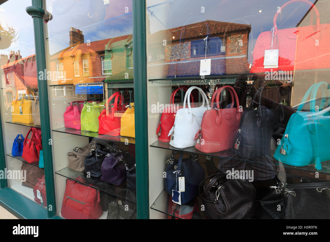 Leather handbags in a high street shop window. Stock Photo