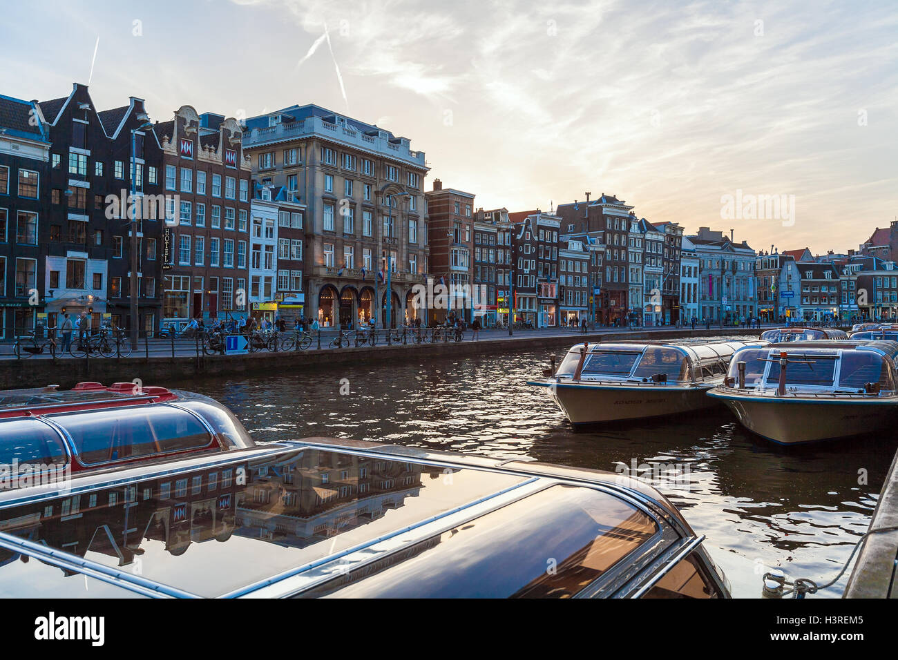 AMSTERDAM, NETHERLANDS - APRIL 3, 2008: The famous dancing old houses along the canal Rokin after sunset Stock Photo