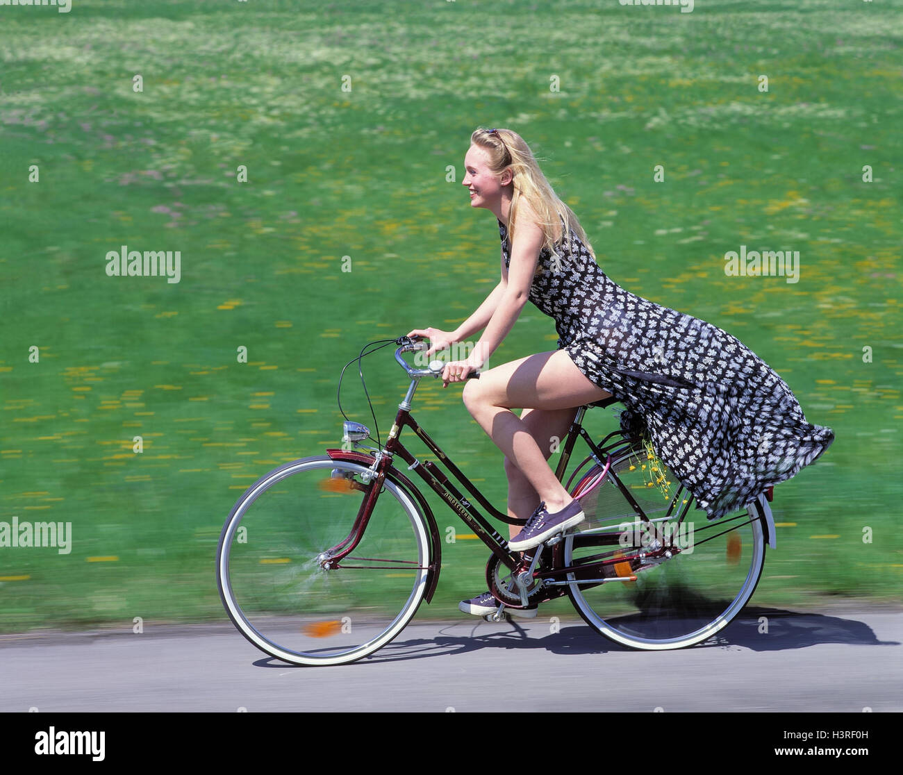 Country road, woman, young, summer dress, riding a bike, street, meadow, teenager, girl, dress, bicycle, go, cyclist, cyclist, leisure time sport, summer Stock Photo