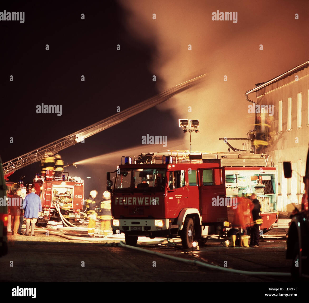 Fire entry, building fire, evening, fire brigade, firefighters, fire, delete, fire-fighting entry, domestic fuel, fire, building, burn, conflagration, firefighting, service vehicle, fire engine, fire ladder, rotary conductor, night Stock Photo