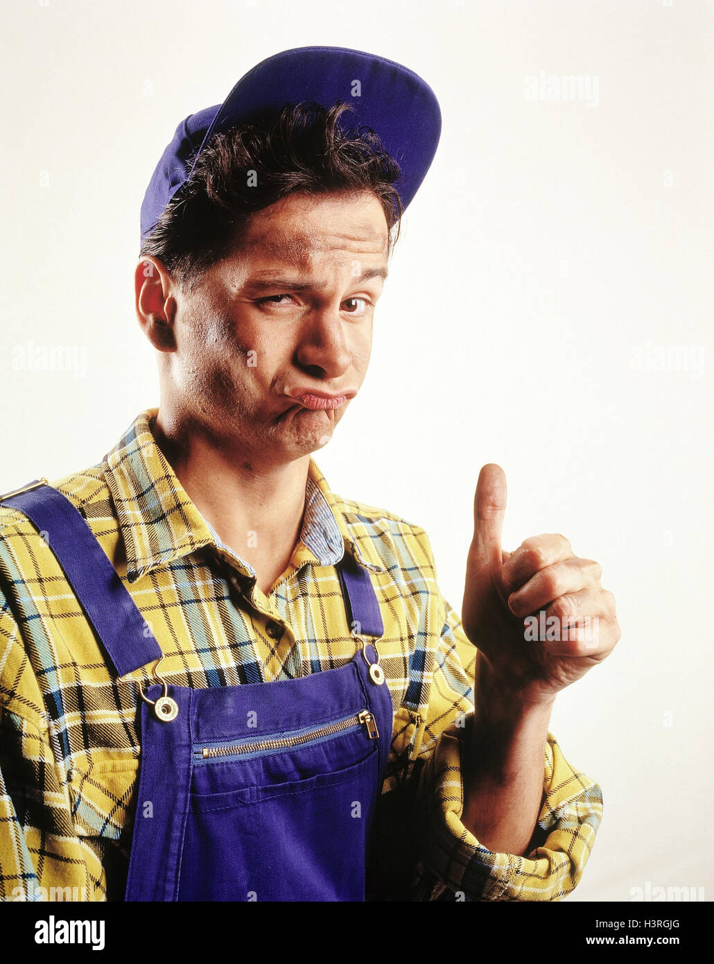 Man, craftsman, gesture, pollex, high studio, cut out, overall, overalls, working clothes, shirt, yellow, checked, sign cap, contently Stock Photo