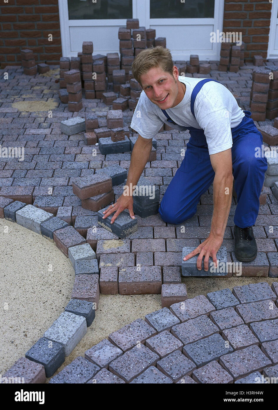Man, paving-stones, lay, young, work, worker, occupation, outside, stone  pavement, paving-stones, Pflasterer, working clothes, stones, cobblestones,  coating, kneel, smile Stock Photo - Alamy