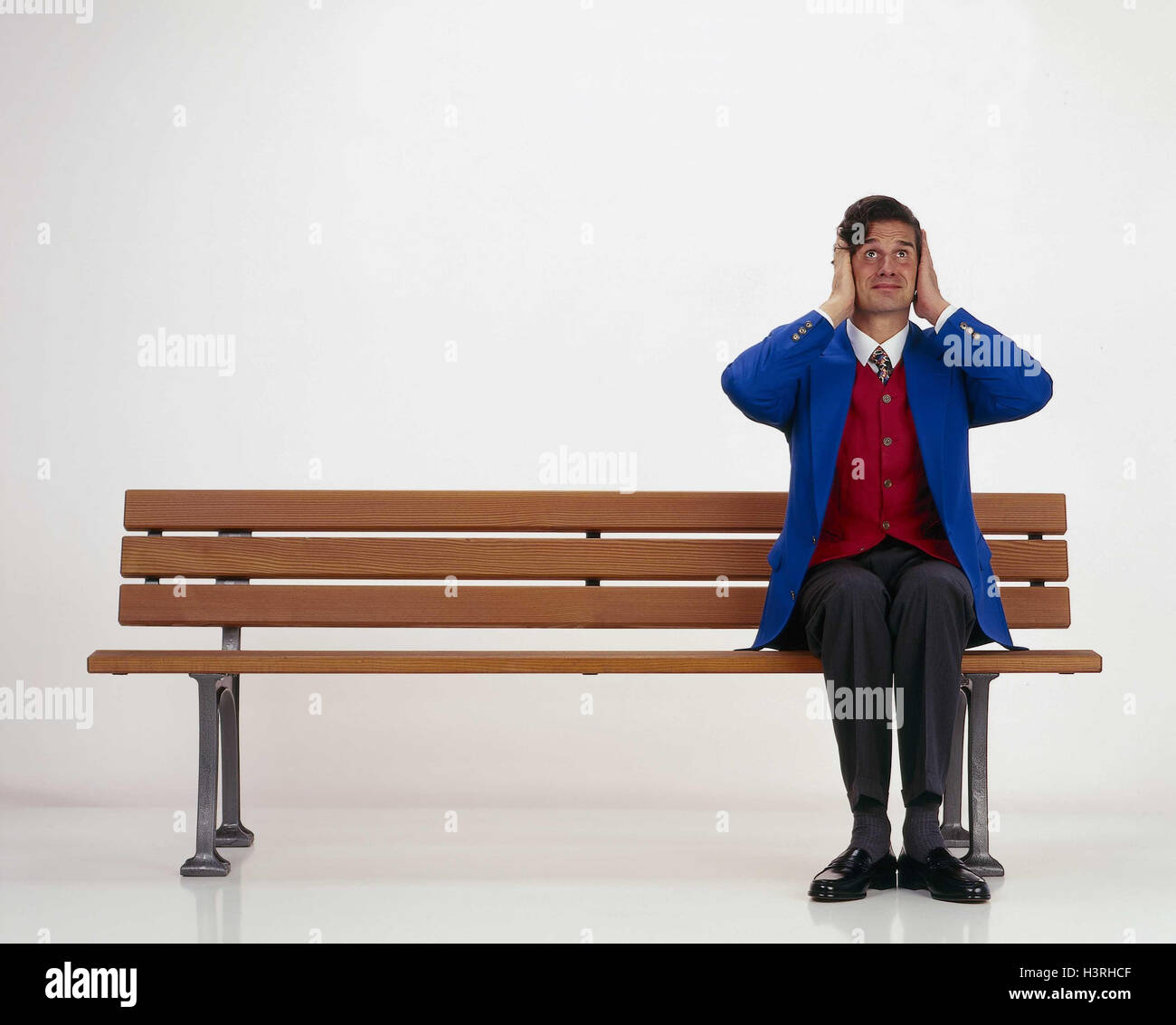 Man, bank, sit, keep closed gesture, ears inside, studio, park-bench, noise, loudly, stress, stressed, overallocated, thrashing, expression Stock Photo