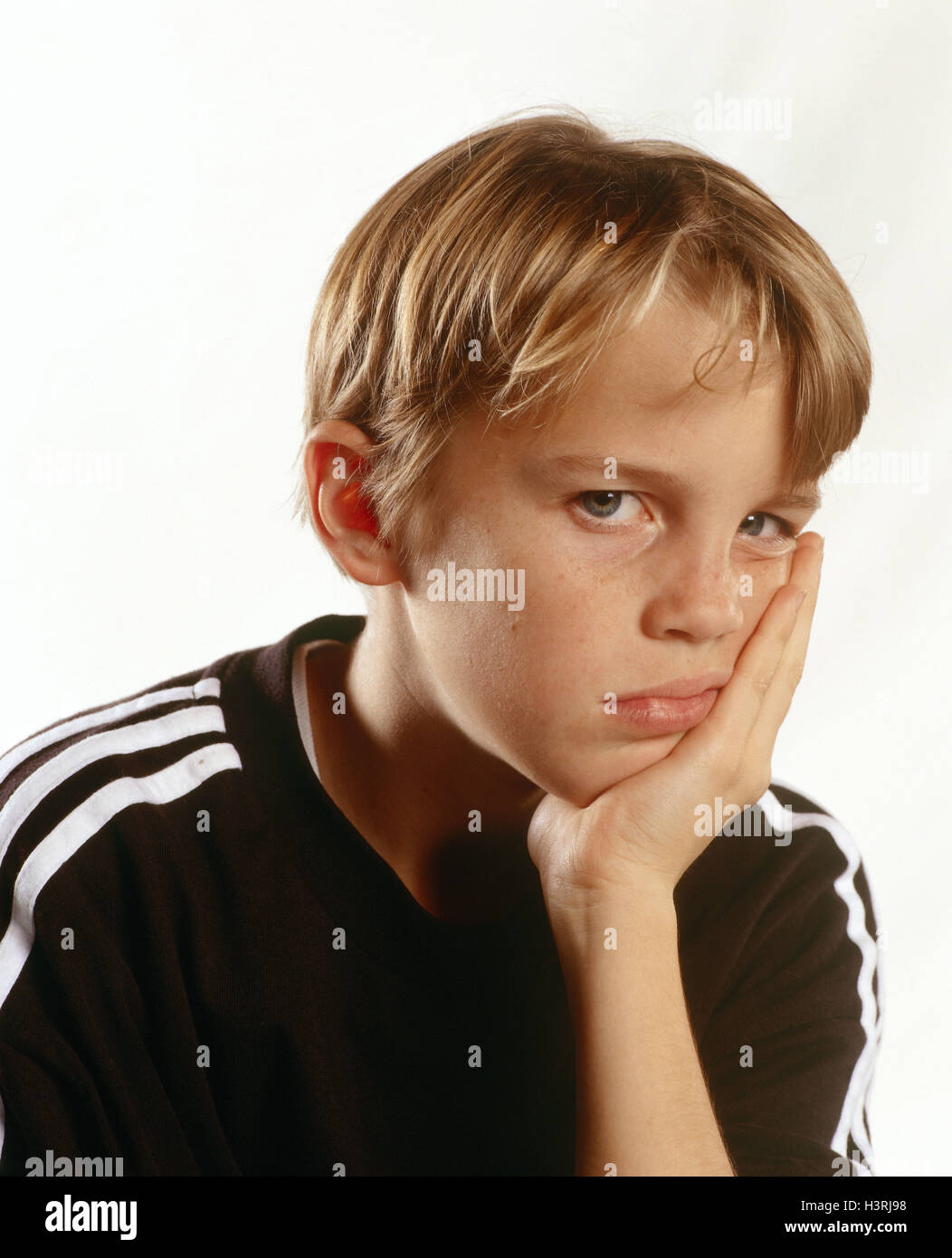 Boy, blond, facial play, boredom, portrait, add support child portrait, child, head, sulk boringly, sadly, offends, defiantly, dissatisfied, view camera, studio, inside Stock Photo
