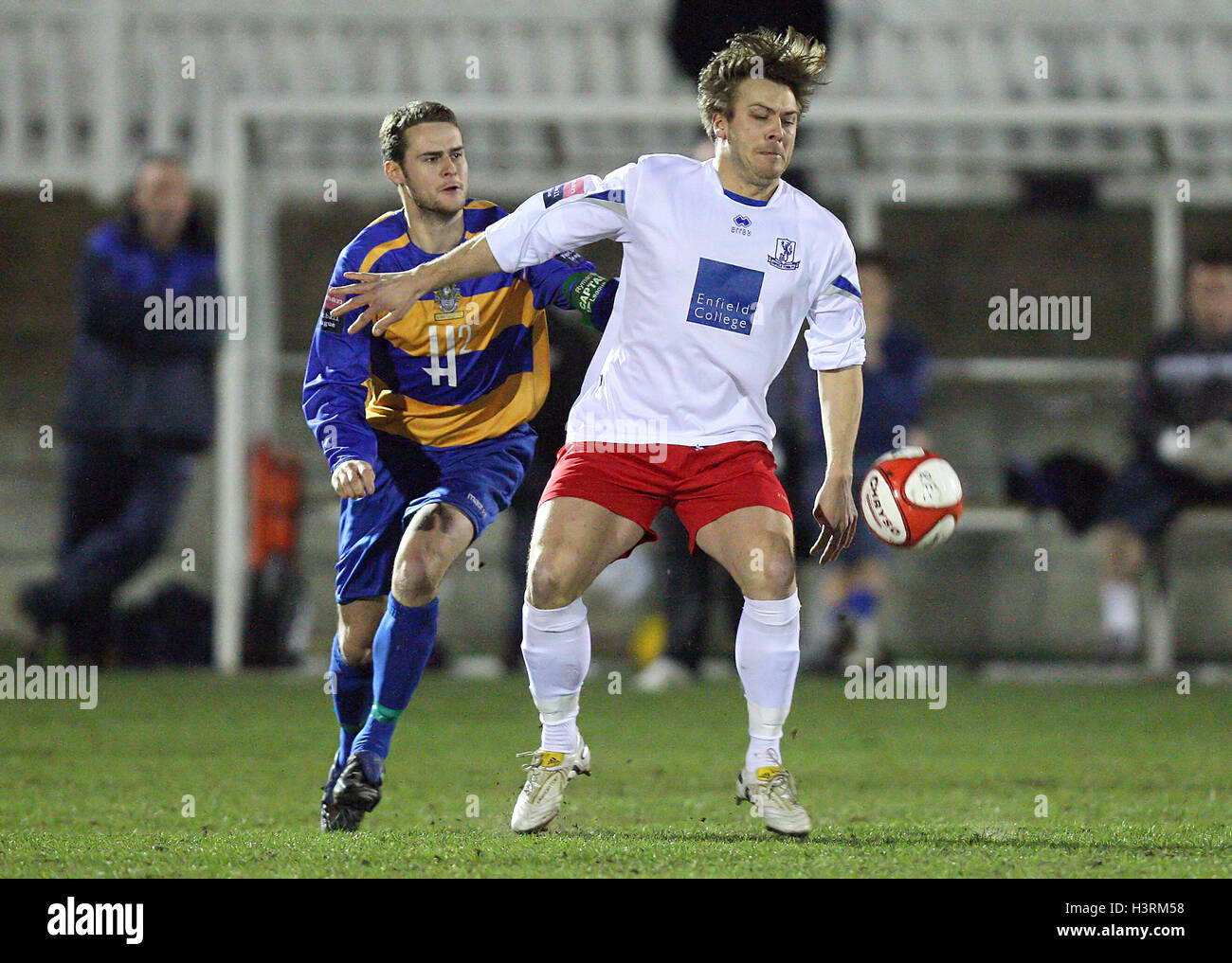 Andy Jones of Enfield Town shields the ball from Paul Clayton of Romford - Romford vs Enfield Town - Ryman League Division One North Football at Mill Field, Aveley FC - 23/03/10 Stock Photo