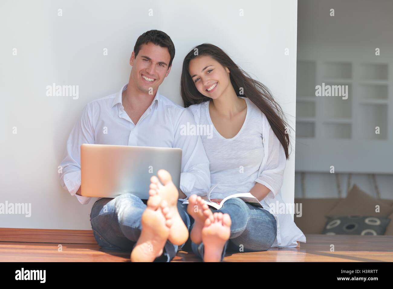 young couple using laptop at home Stock Photo - Alamy