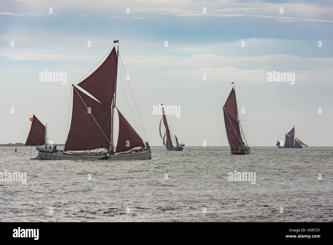 Four Thames sailing barges tacking into the wind as they leave the