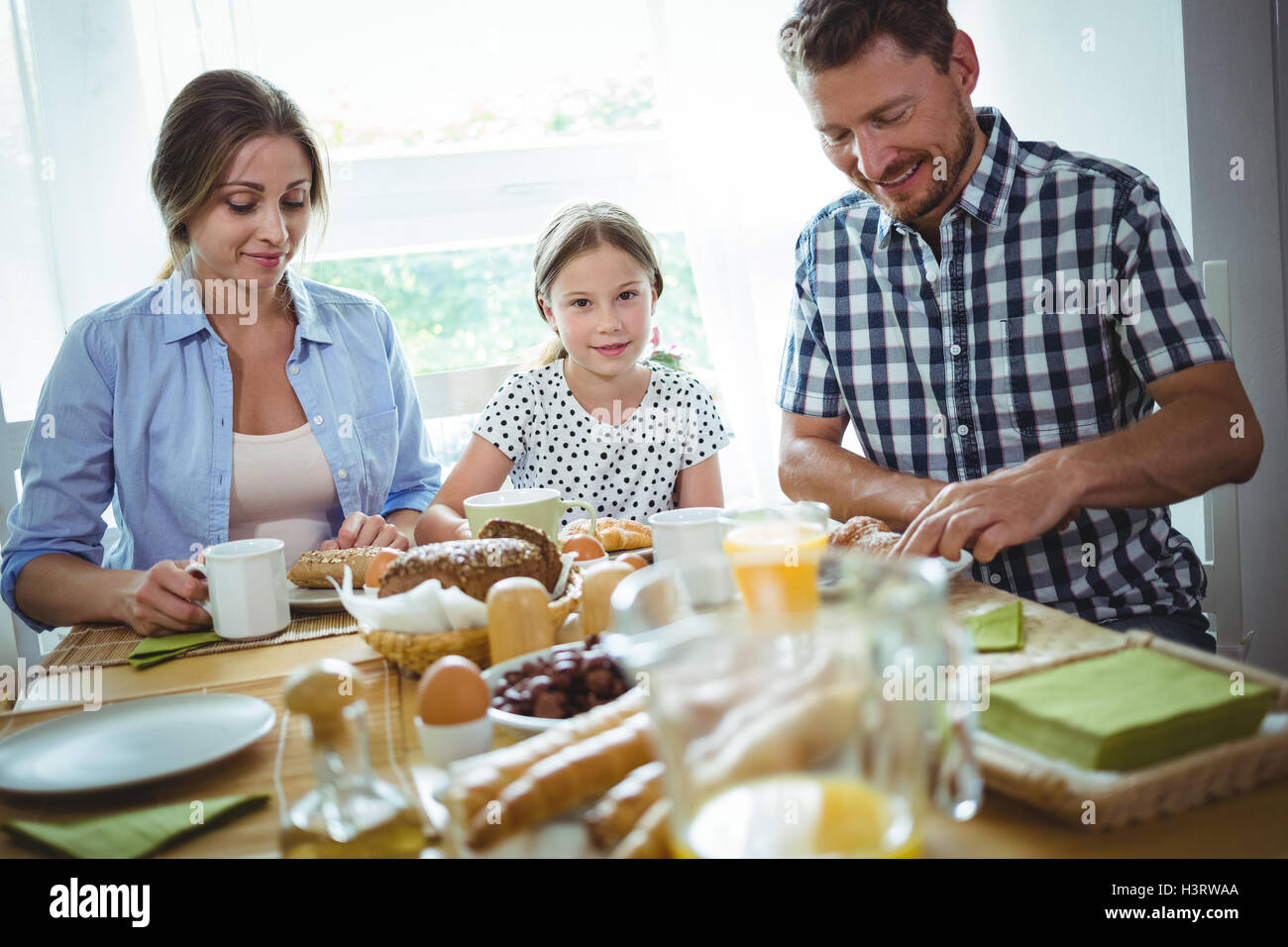 Happy family having breakfast Stock Photo - Alamy
