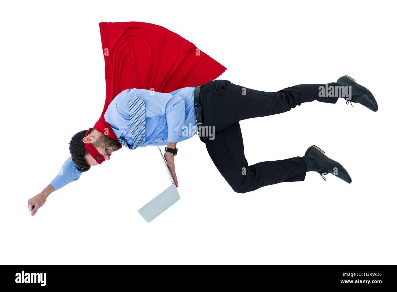 Businessman pretending to be a super hero holding laptop Stock Photo
