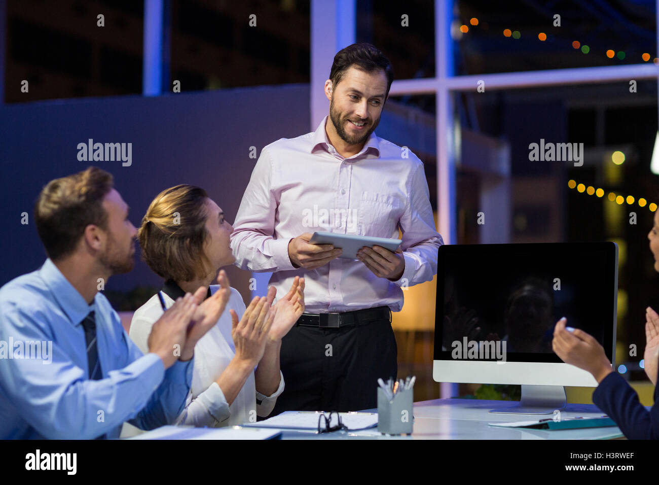 Businesspeople applauding on their colleagues presentation Stock Photo ...