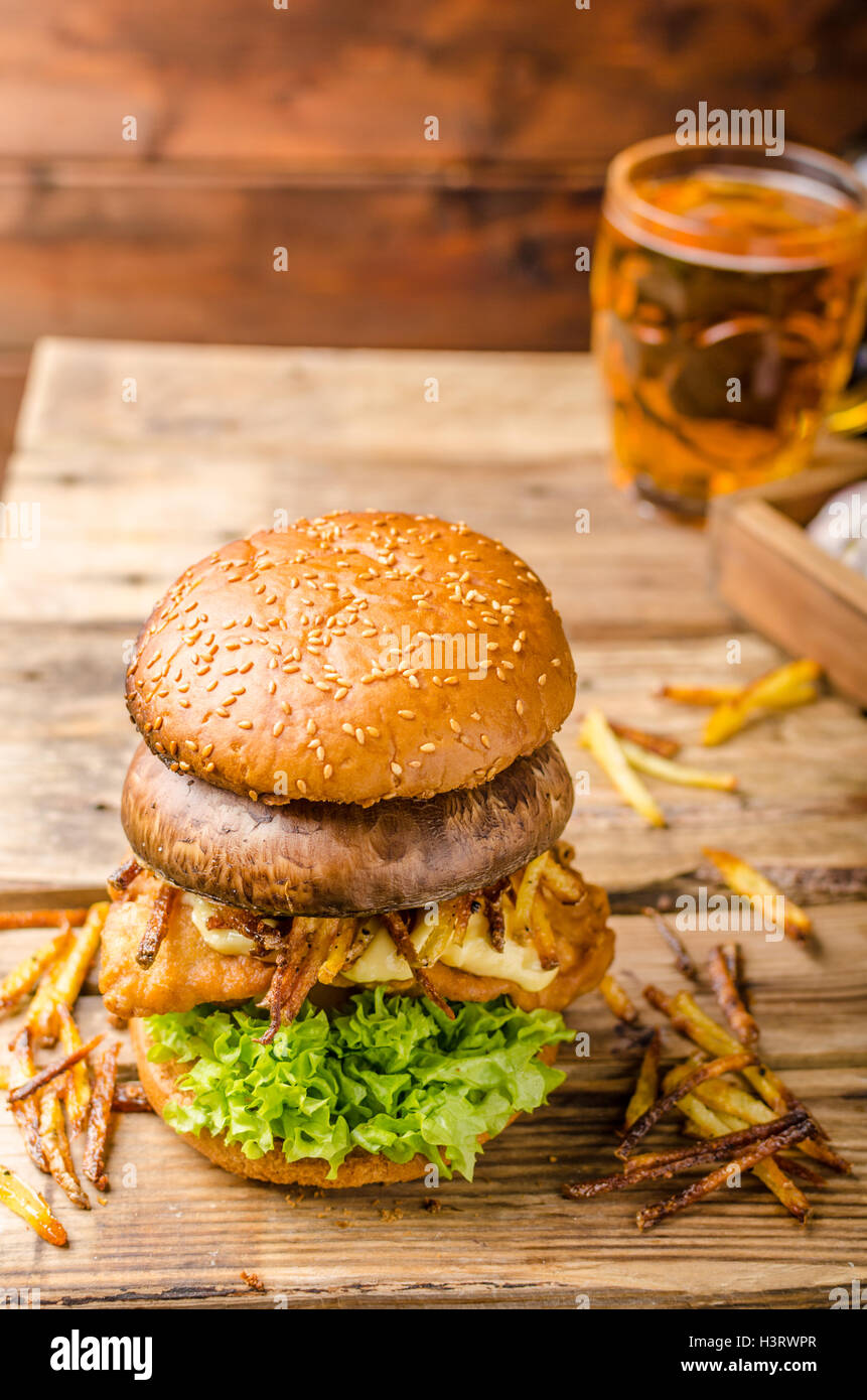 Fish and Chips Burger with fried potato straw and grilled portobello