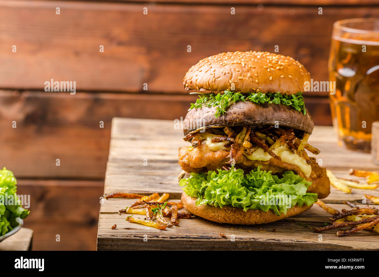 Fish and Chips Burger with fried potato straw and grilled portobello