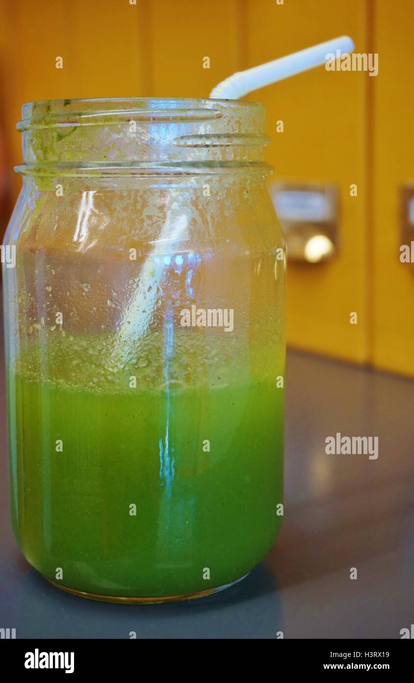 A green kale mojito smoothie in a jar on a desk in an office Stock ...