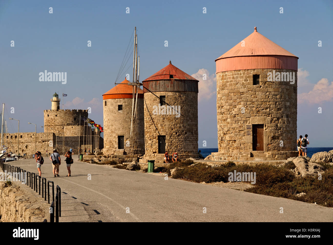 Old windmills at Rhodes city harbour, Island of Rhodes, Dodecanese island group, Greece. Stock Photo