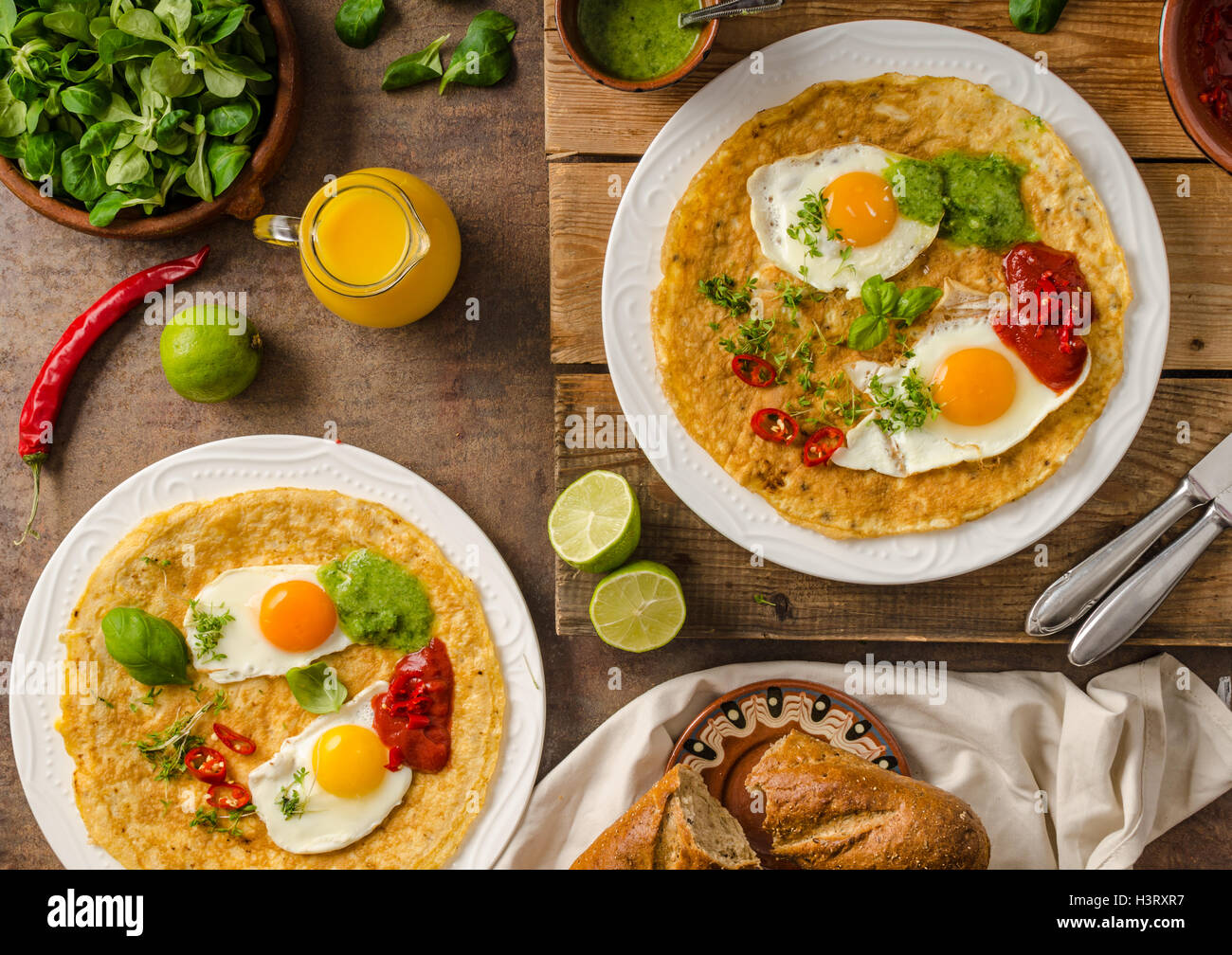 Huevos divorciados, delicious food with eggs, fresh salad and herbs and spicy and herby sauce Stock Photo