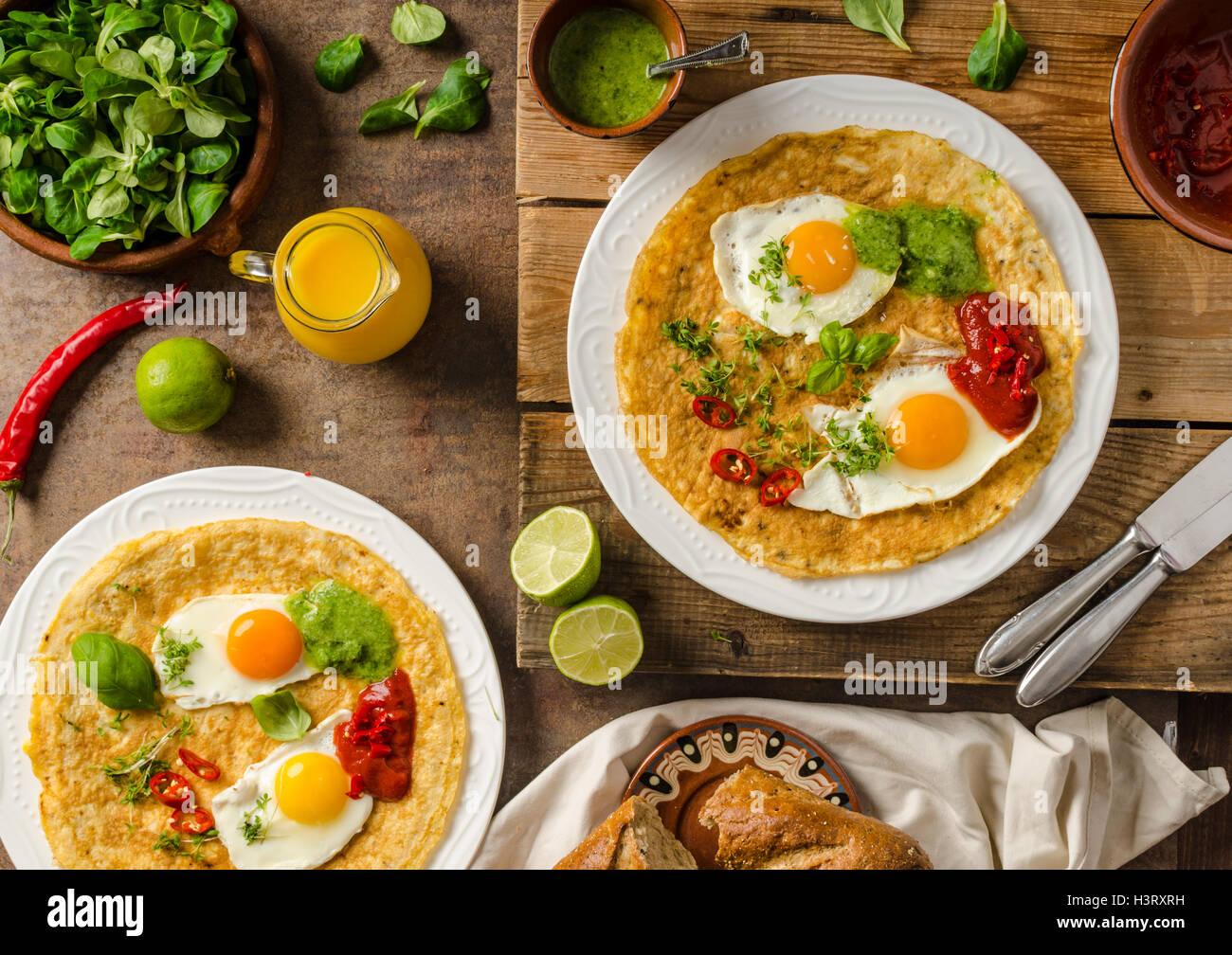 Huevos divorciados, delicious food with eggs, fresh salad and herbs and spicy and herby sauce Stock Photo