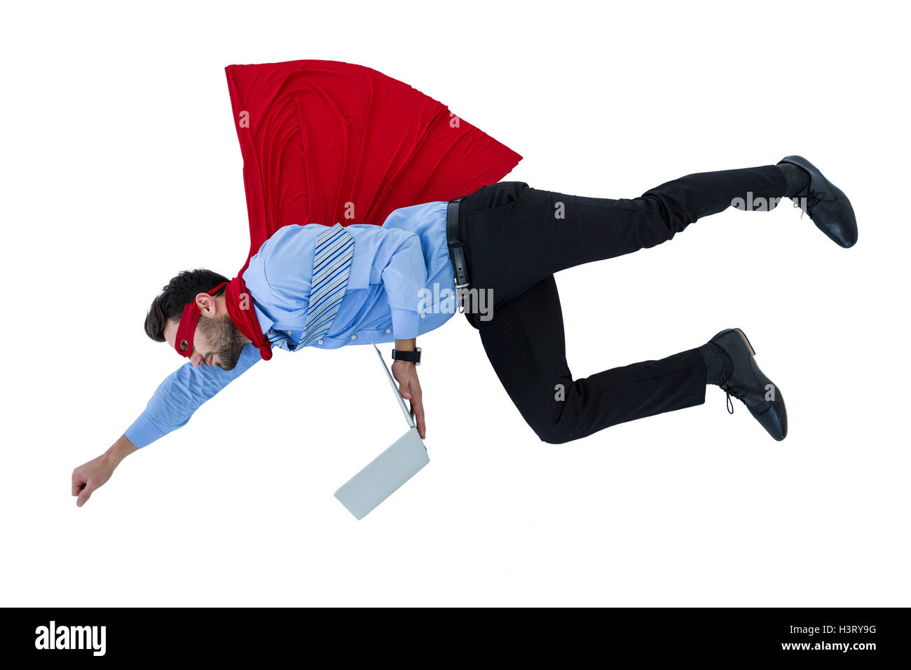 Businessman pretending to be a super hero holding laptop Stock Photo