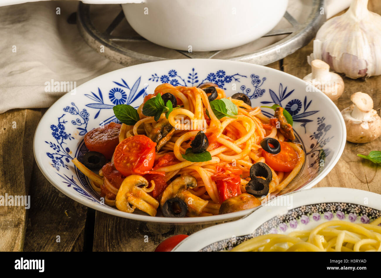 Pasta with olives, tomatoes and basil, fresh pasta, orange juice Stock