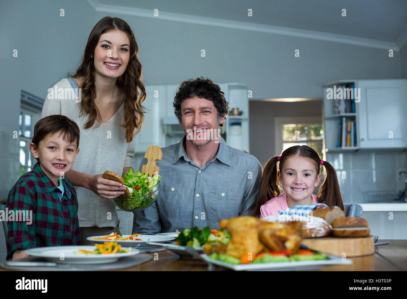 Portrait of happy family having breakfast Stock Photo - Alamy