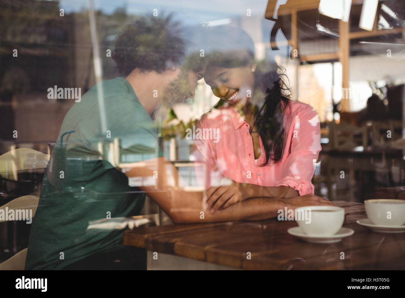 Couple romancing in cafeteria Stock Photo