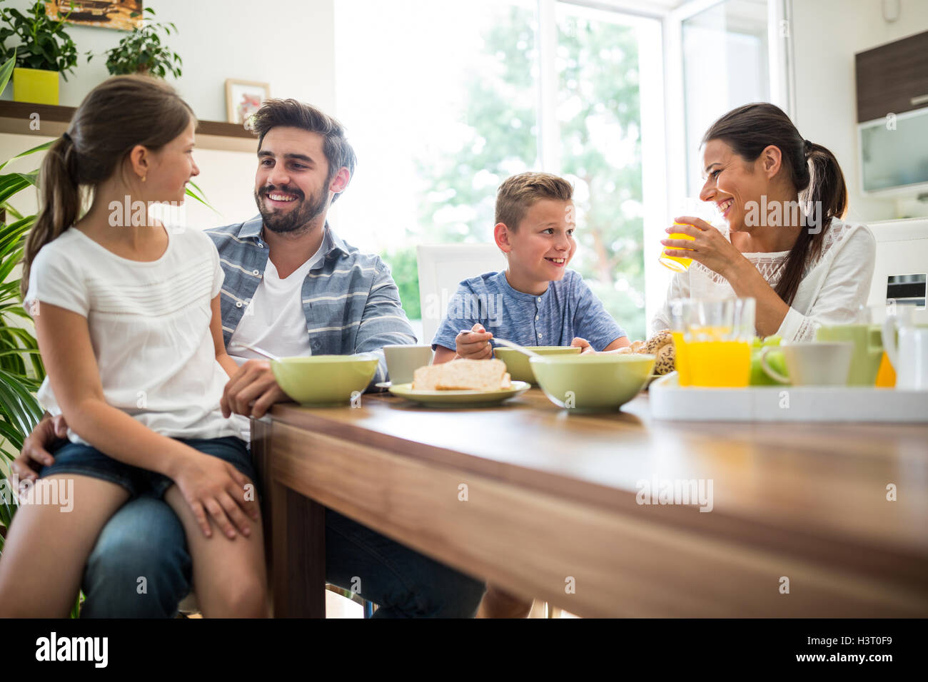 Happy family having breakfast Stock Photo - Alamy
