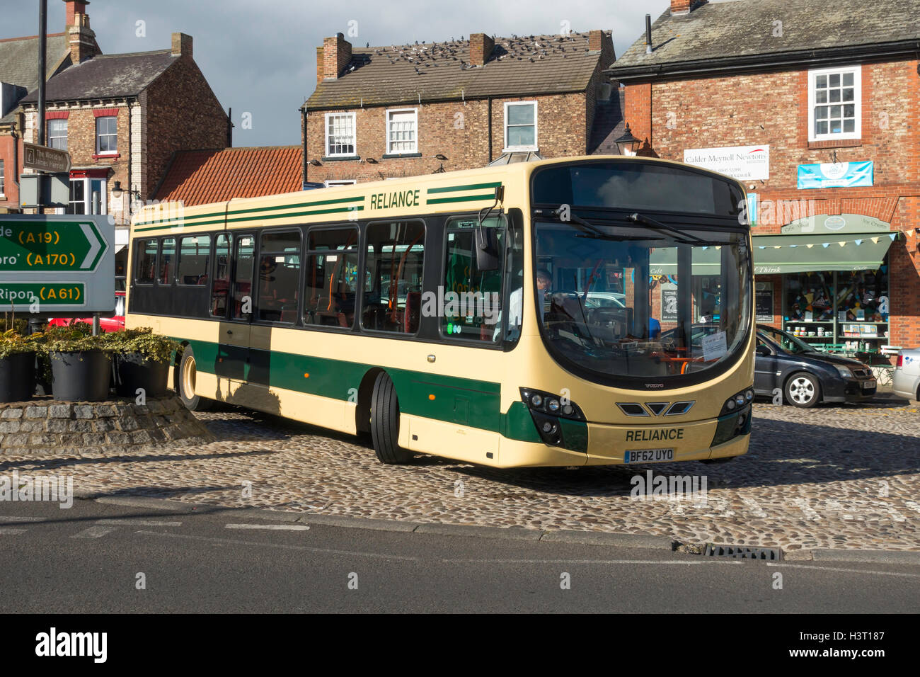 Reliance bus stopped at Thirsk Town Centre Market place while the driver has a break before departing for York Stock Photo