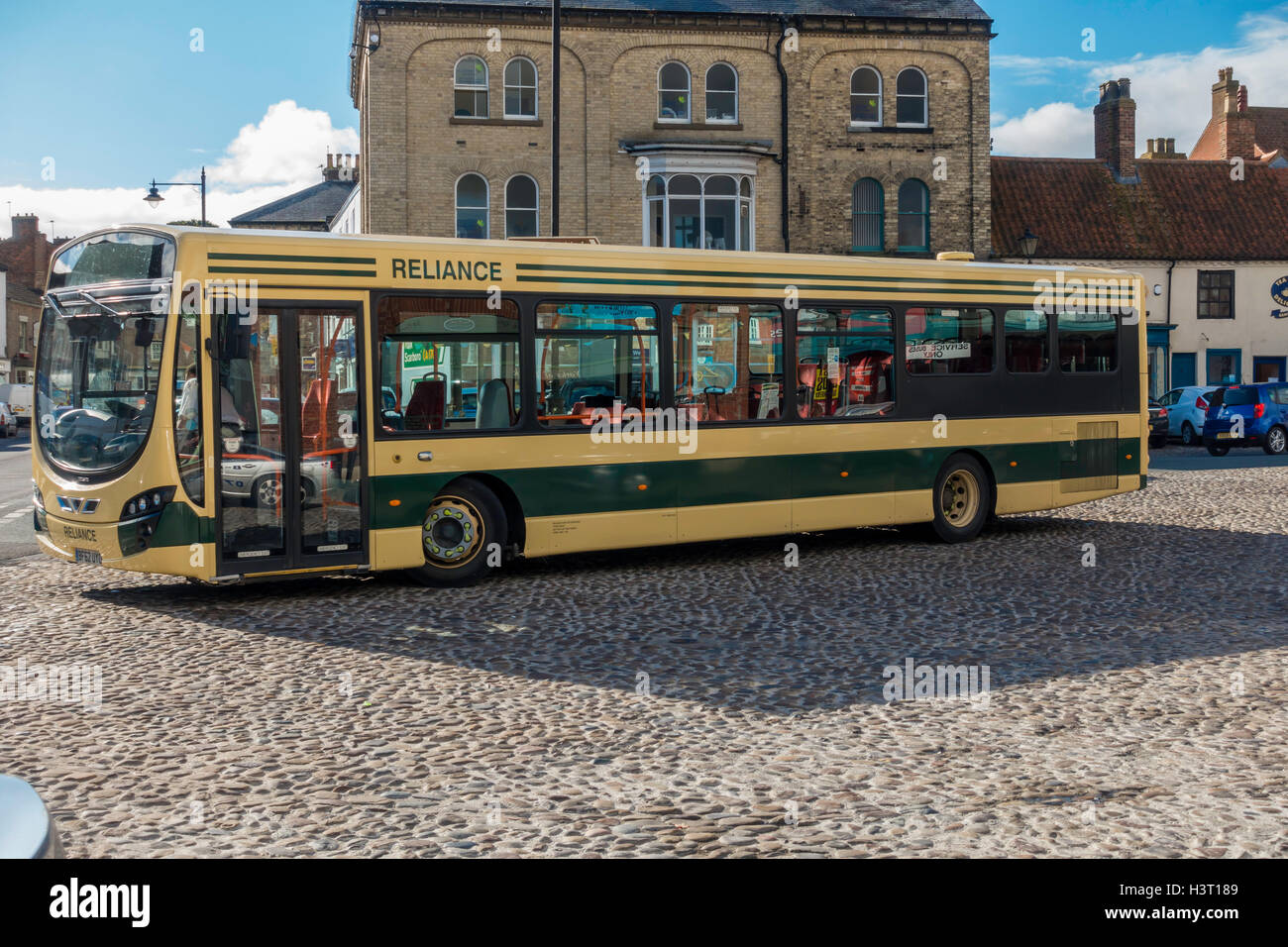 Reliance bus stopped at Thirsk Town Centre Market place while the driver has a break before departing for York Stock Photo