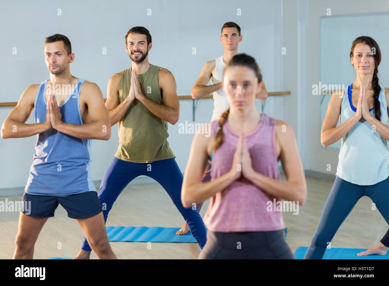 Group of people performing yoga Stock Photo - Alamy