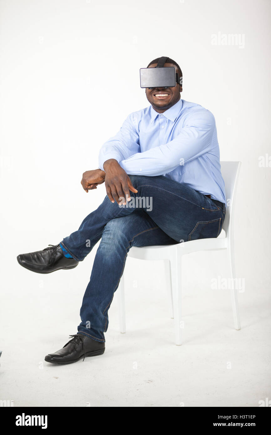 Man sitting on chair and using virtual reality headset Stock Photo Alamy