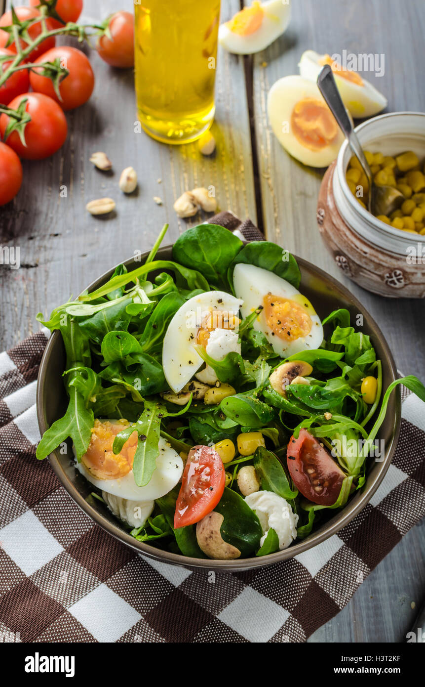 Lamb lettuce salad with eggs, roasted nuts, mozzarella and corn Stock