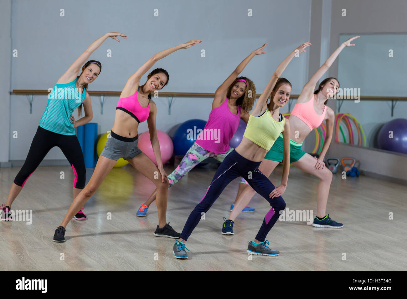 Group of fitness team performing stretching exercise Stock Photo - Alamy
