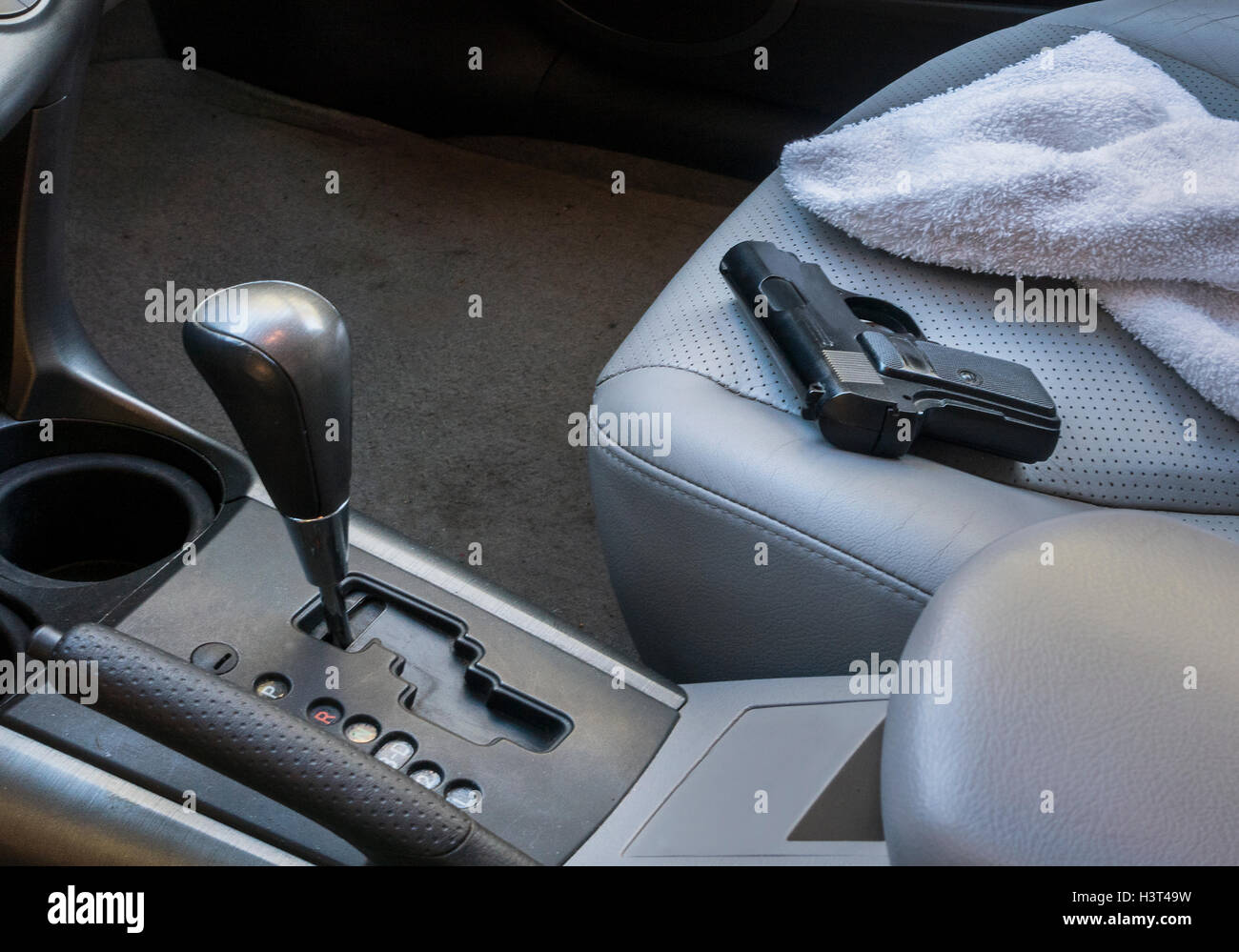 gun on seat in car Stock Photo