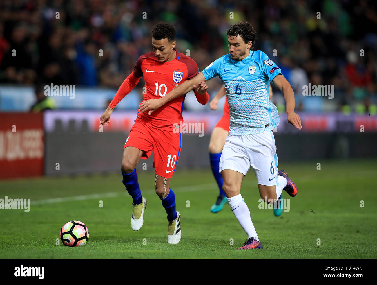 England's Dele Alli (left) and Slovenia's Rene Krhin (right) battle for the ball during the 2018 FIFA World Cup Qualifying match at the Stozice Stadium, Ljubljana. Stock Photo