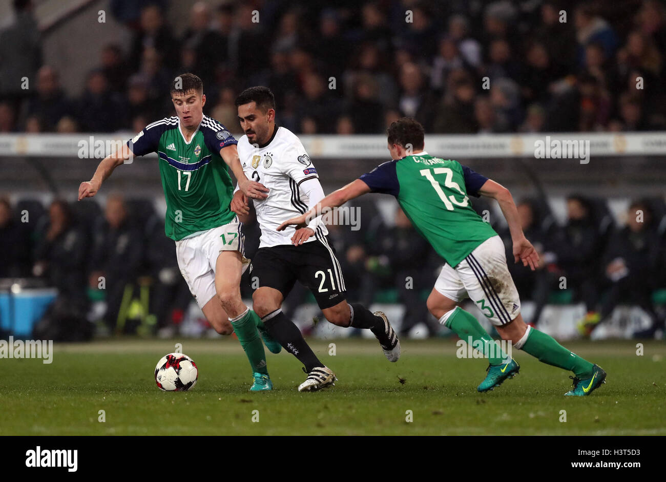 Germany's IIkay Gundogan battles for the ball with Northern Ireland's Paddy McNair (left) and Corry Evans (right) during the 2018 FIFA World Cup Qualifying match at the HDI Arena, Hannover. Stock Photo