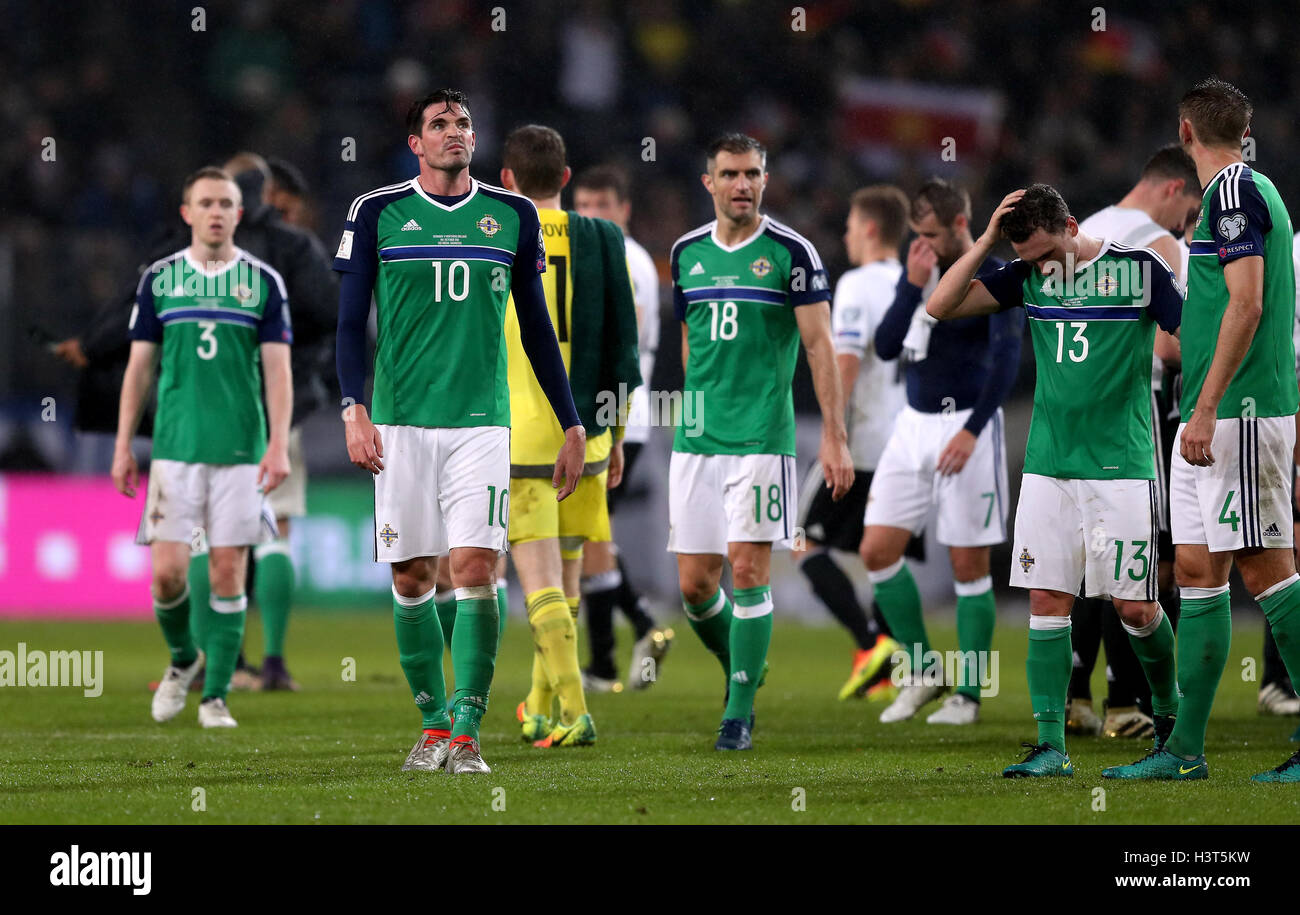 Northern Ireland's Kyle Lafferty (left) and his team-mates appear dejected after the 2018 FIFA World Cup Qualifying match at the HDI Arena, Hannover. Stock Photo