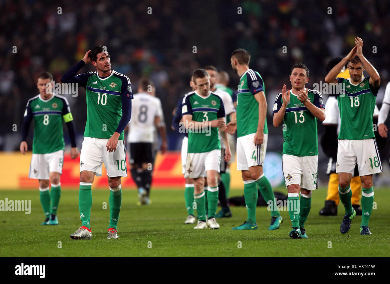 Northern Ireland's Kyle Lafferty (left), Corry Evans and their team-mates appear dejected after the 2018 FIFA World Cup Qualifying match at the HDI Arena, Hannover. Stock Photo