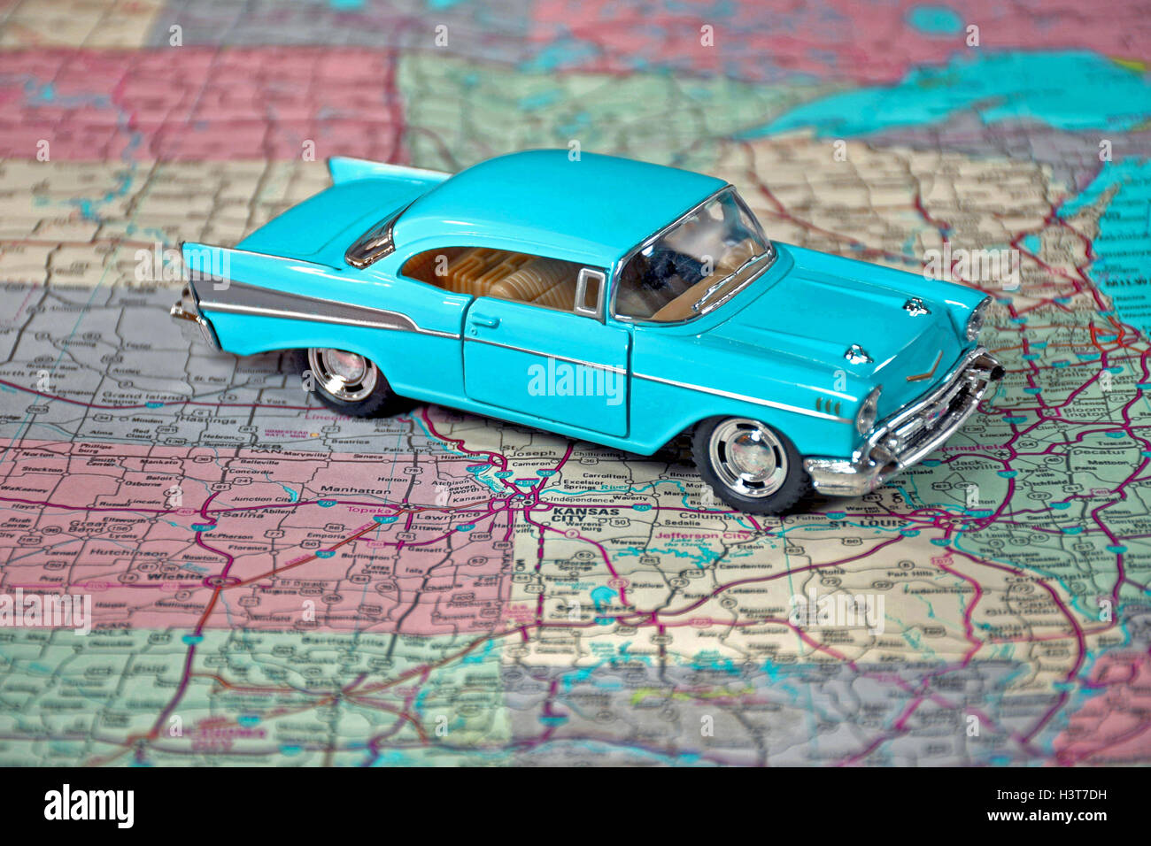 close up of turquoise retro car on road map Stock Photo
