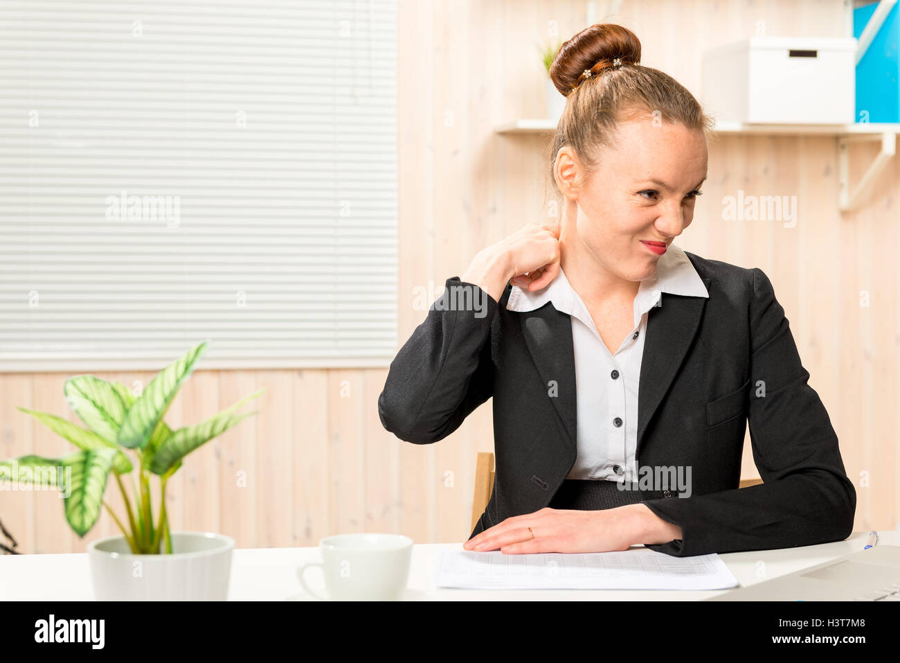 tired accountant rubbing sore neck in the office Stock Photo - Alamy