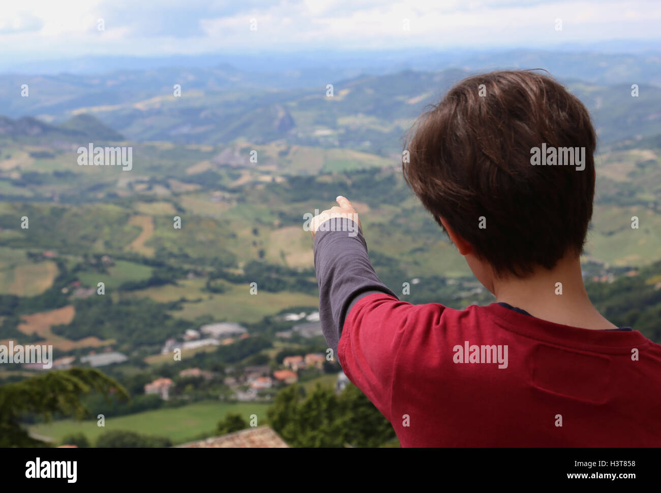 young boy shows the beautiful landscape of the Apennines Mountains in Italy Stock Photo