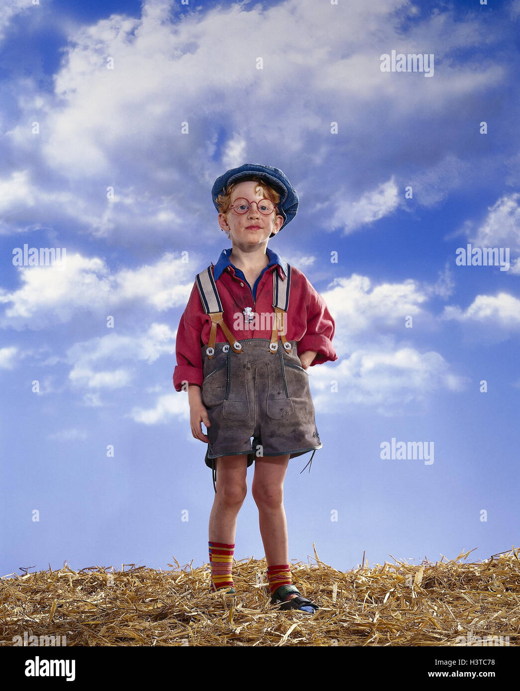 small boy, leather ball trousers, straw, cloudy sky mb 57 A2 Stock Photo