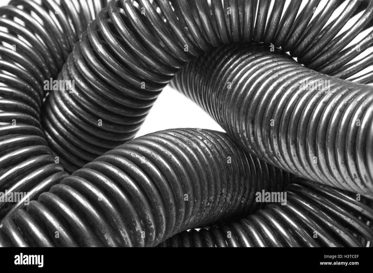 Coiled old metal spring abstract background close up Stock Photo