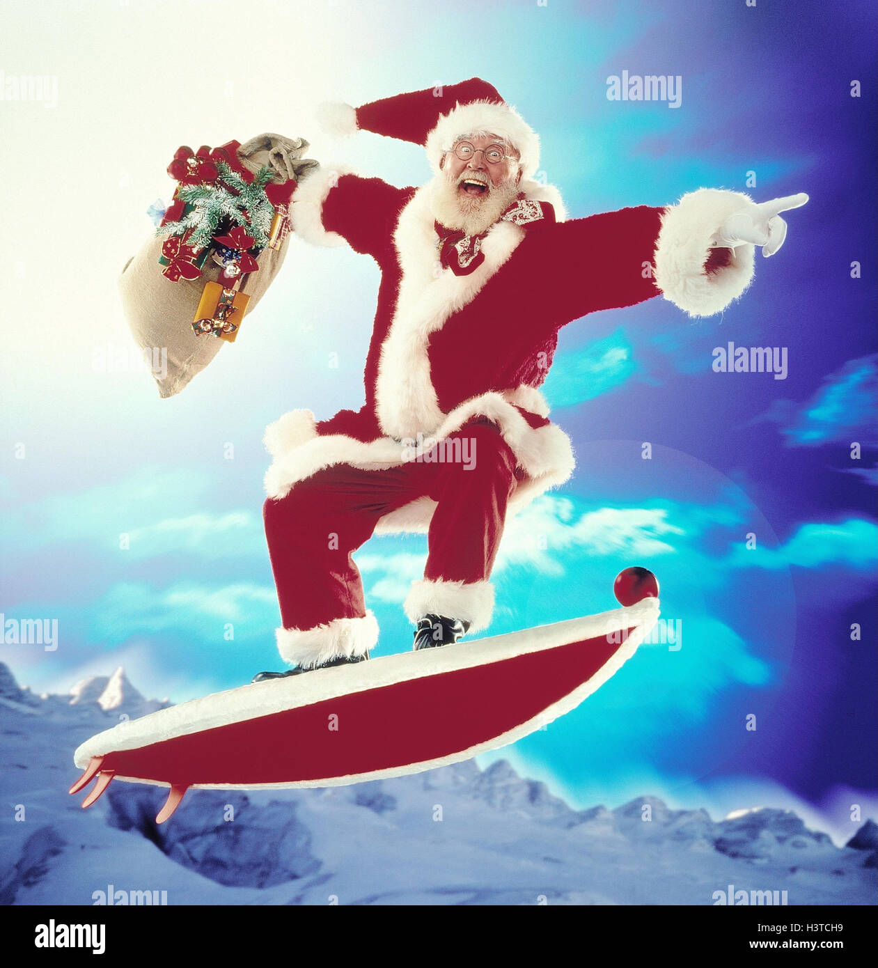 Santa Claus, surfboard, 'fly', pouch, presents yule tide, Christmas, Santa, Santa Claus, 'surf the internet', deliver Christmas presents, mountains, heavens, Composing, studio Stock Photo