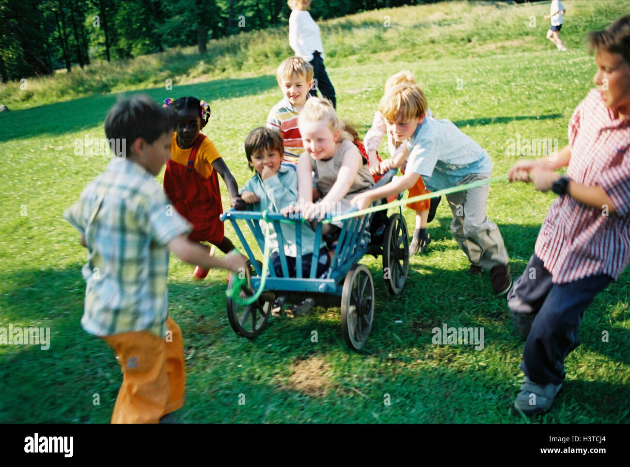Children, group, skin colour differently, handcarts, drag, game, fun, summer, outside youth, childhood, friends, friendship, boy, girl, nationality, passed away, difference, leisure time, amusement, happy, melted, lighthearted, carriages, conductor carria Stock Photo