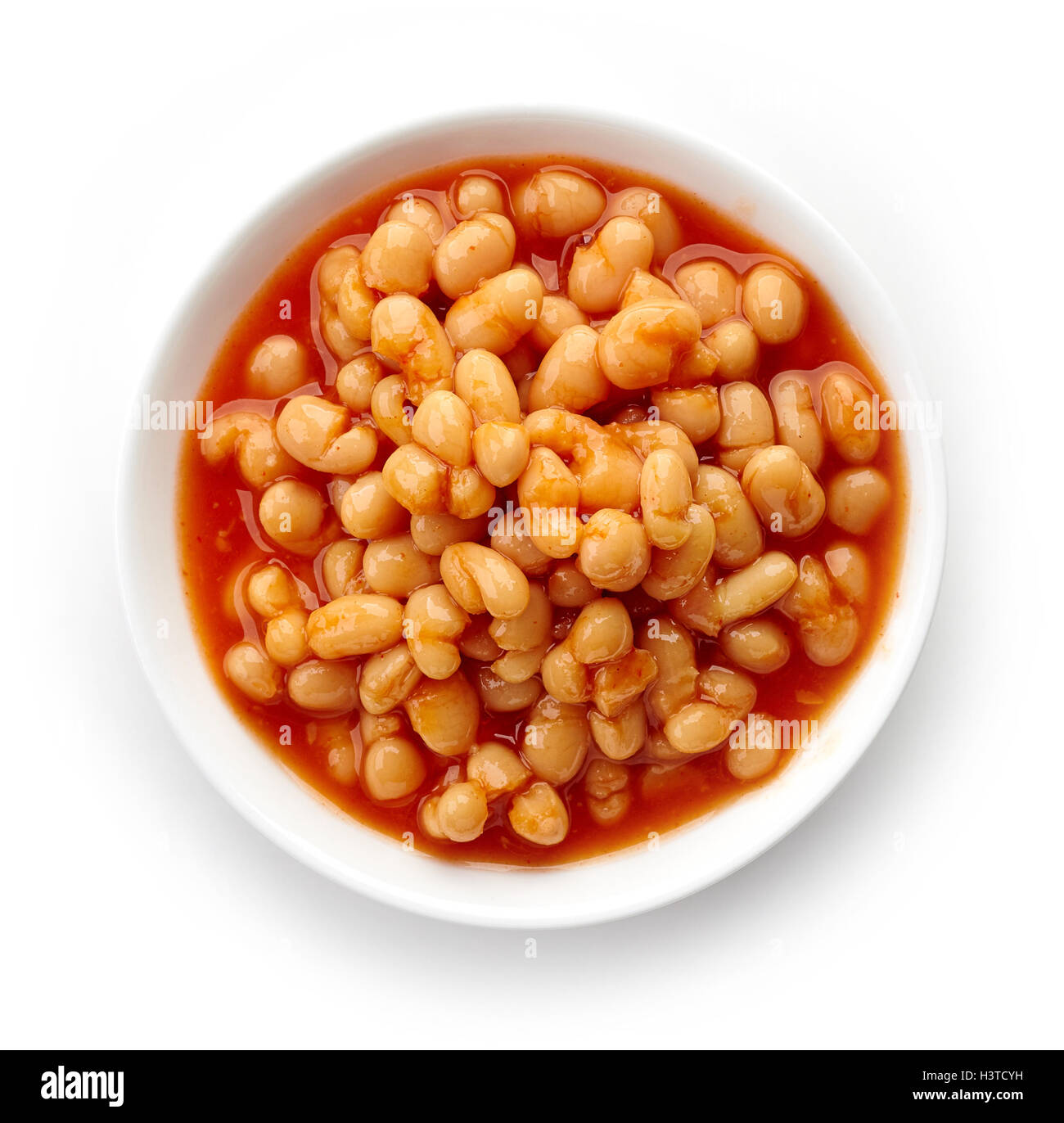Bowl of beans in tomato sauce isolated on white background, top view Stock Photo