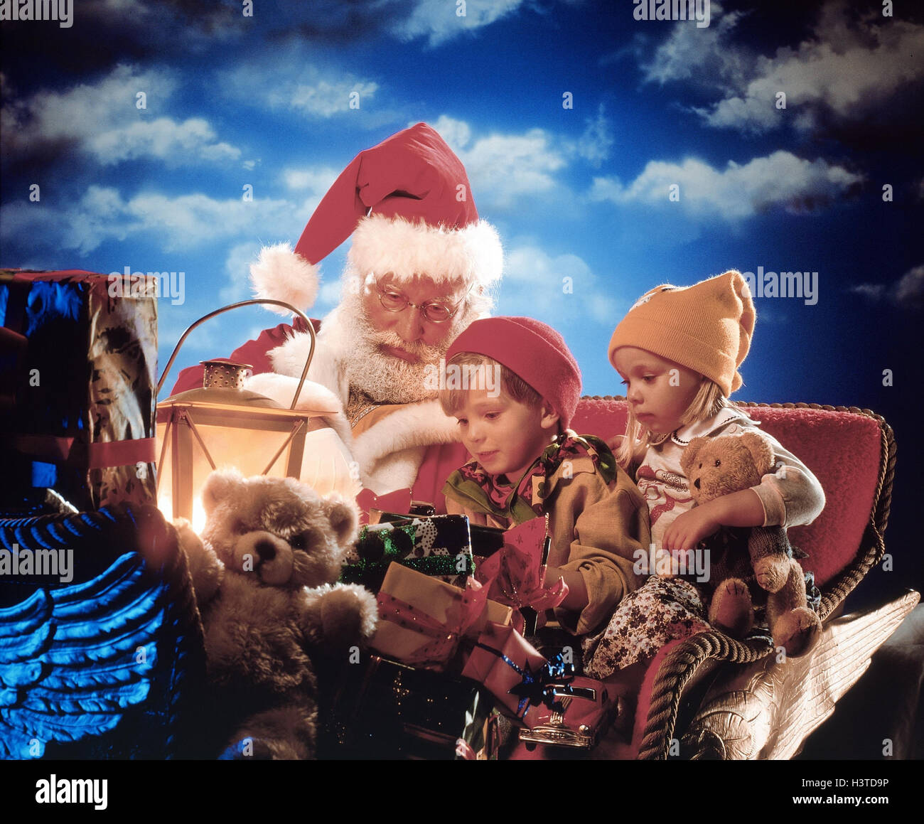 Slides, Santa Claus, children, presents Composing, Christmas, Santa Claus, boy, girl, Christmas presents, packages, teddy bears, lantern Stock Photo
