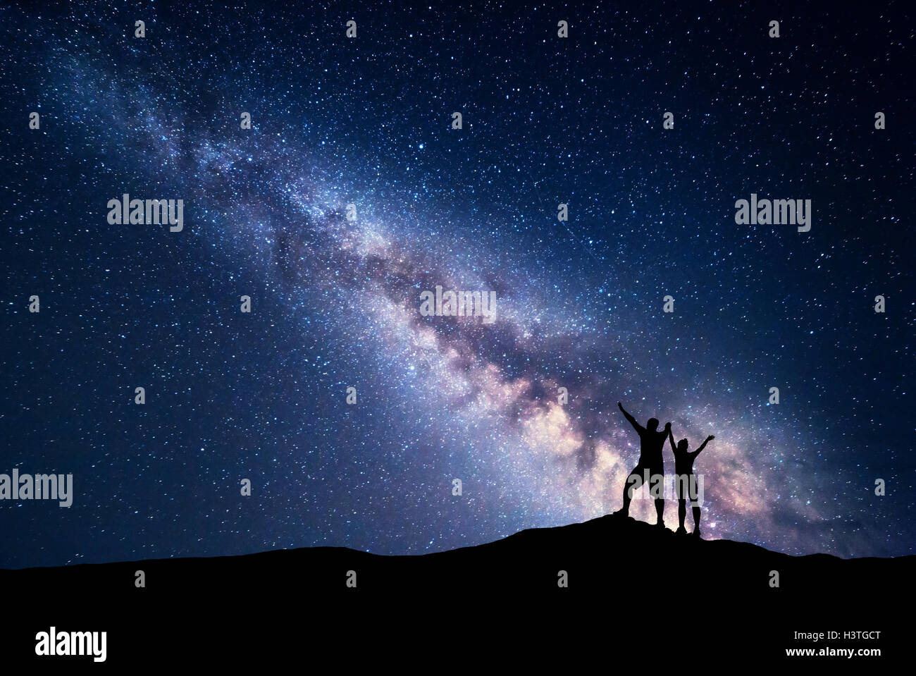 Milky Way. Night sky with stars and silhouette of standing happy man ...