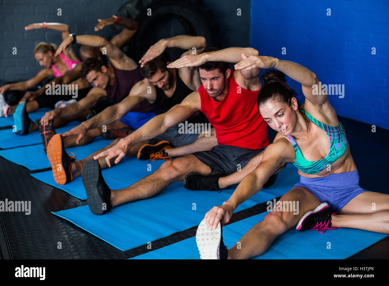 Young athletes doing stretching exercise Stock Photo Alamy