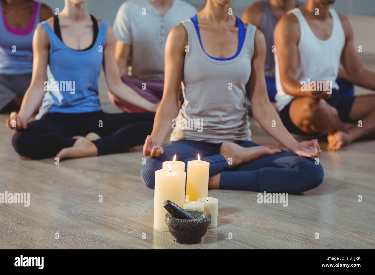 Group of people performing yoga Stock Photo - Alamy