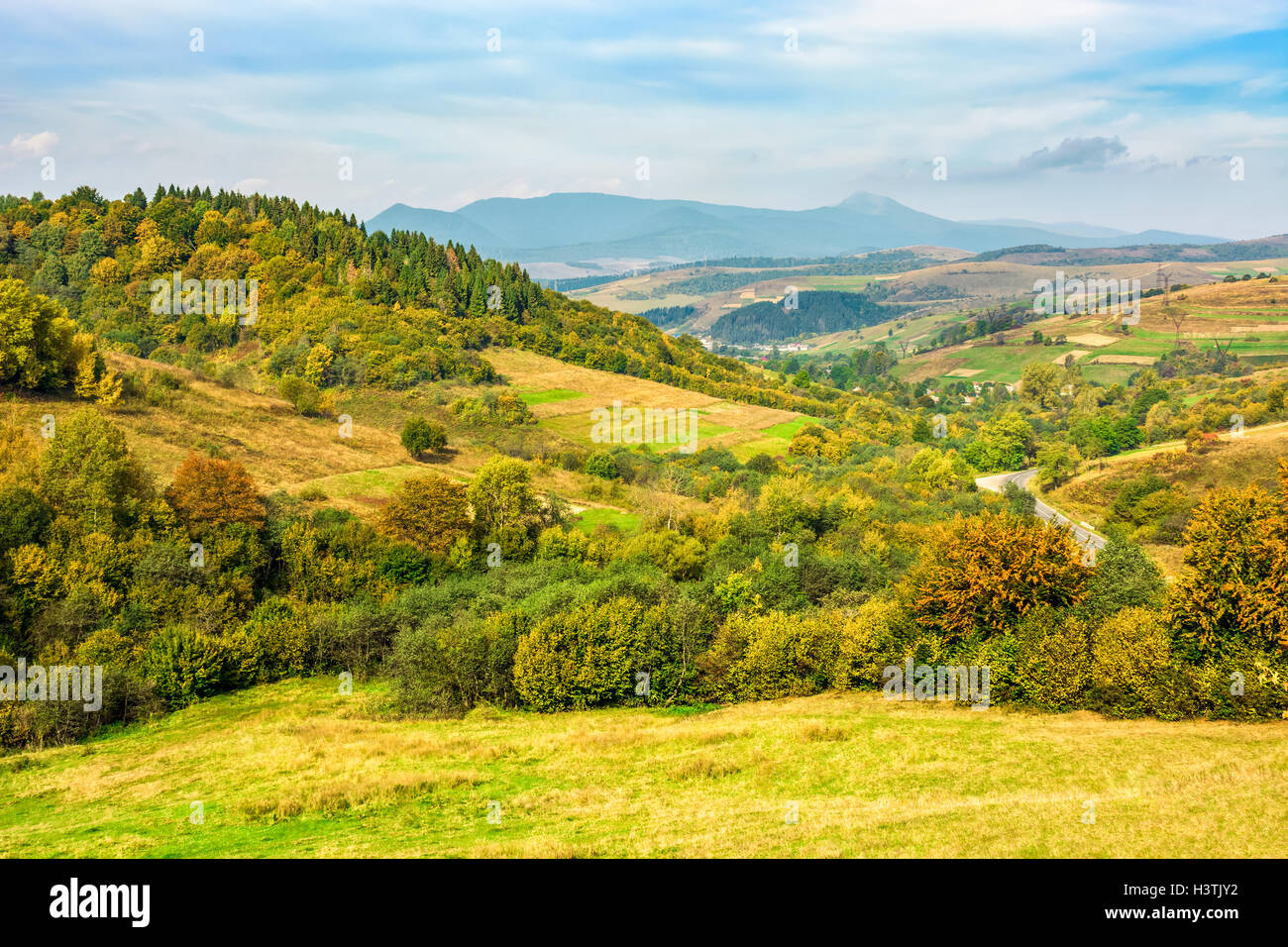 Rural landscape with fields and forest on hillsides of Carpathian mountain rang Stock Photo
